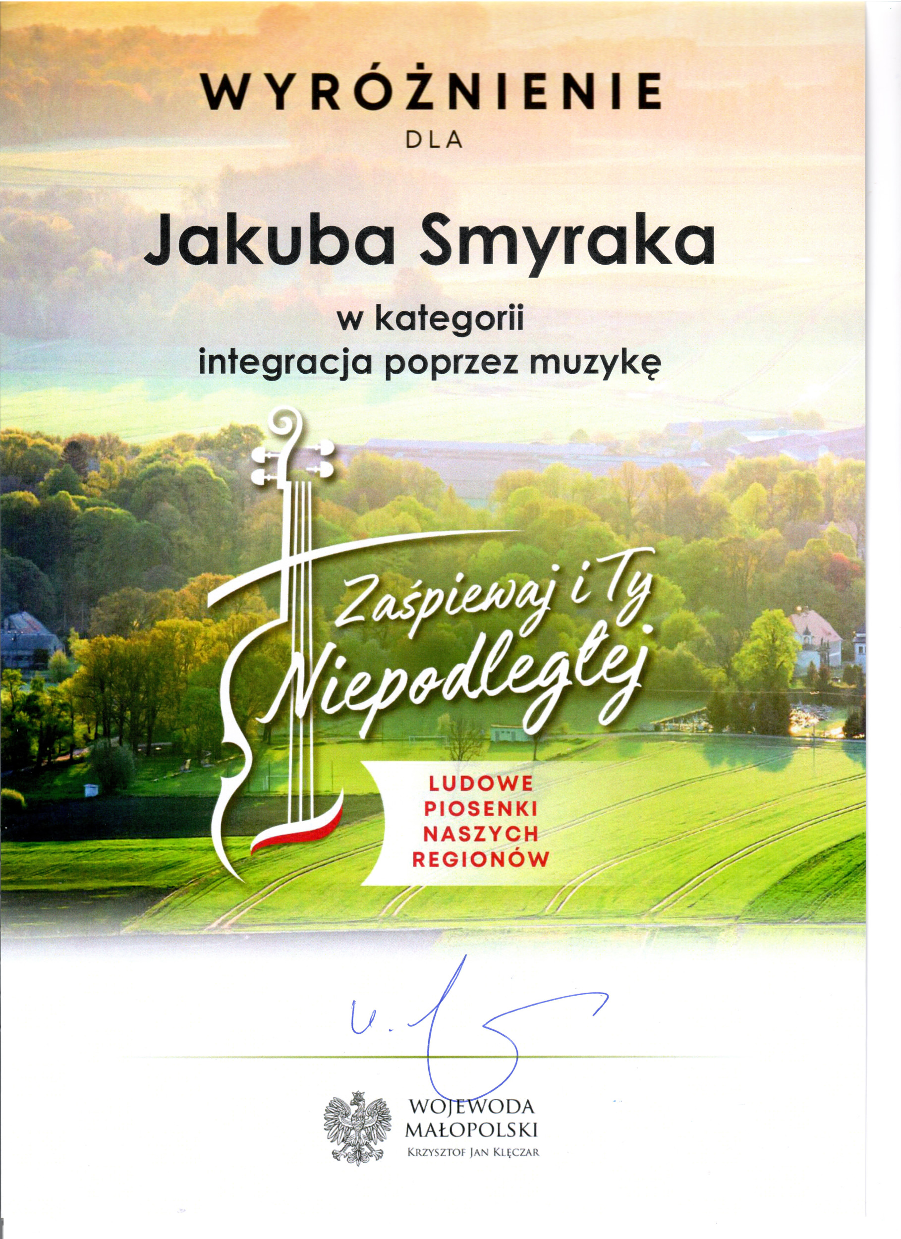 Dyplom wyróżnienia dla Jakuba Smyraka w kategorii "integracja poprzez muzykę" w ramach projektu "Zaśpiewaj i Ty Niepodległej" podpisany przez Wojewodę Małopolskiego.