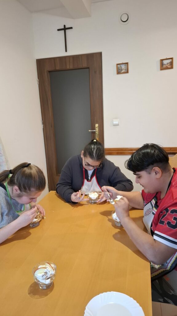 Trzy osoby degustują przygotowaną przez siebie szarlotkę.